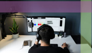 Web designer focused intently on his computer screen, working on a WordPress project in a well-lit office setup, showcasing his professional environment.